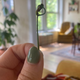 Author holding up a loosely tied cherry stem